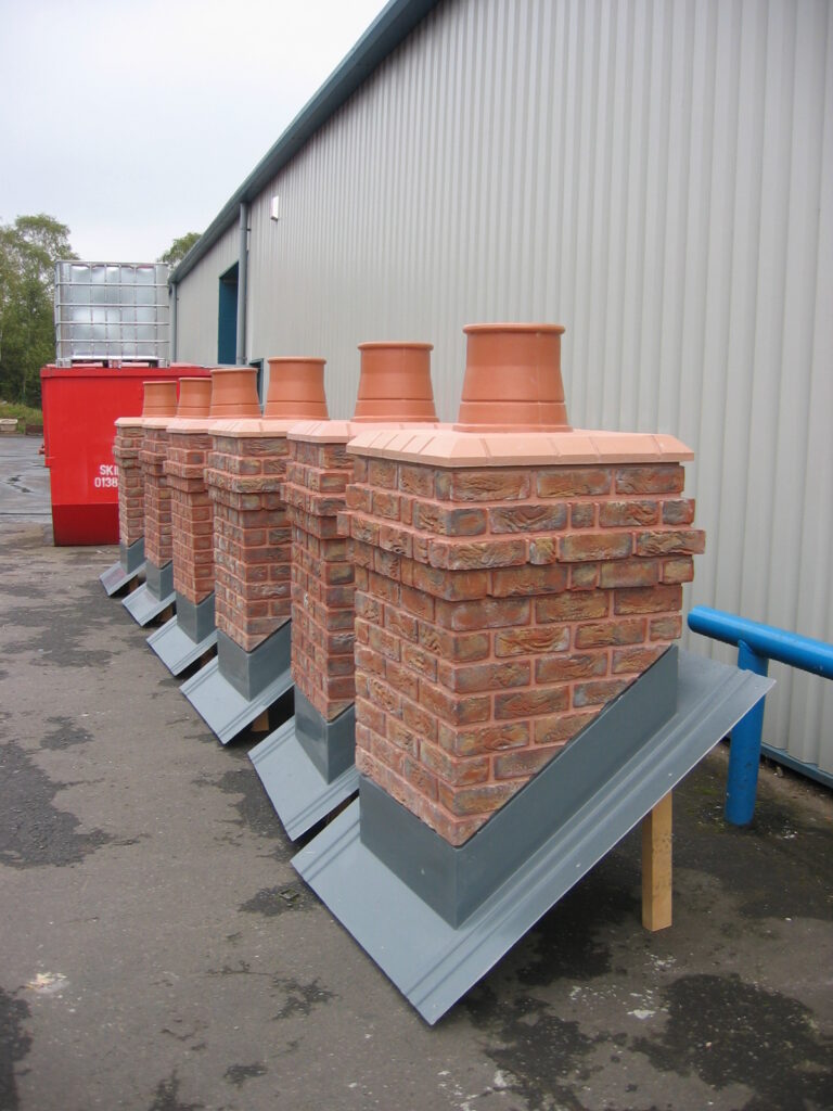 Six large brick-effect chimneys ready for installation