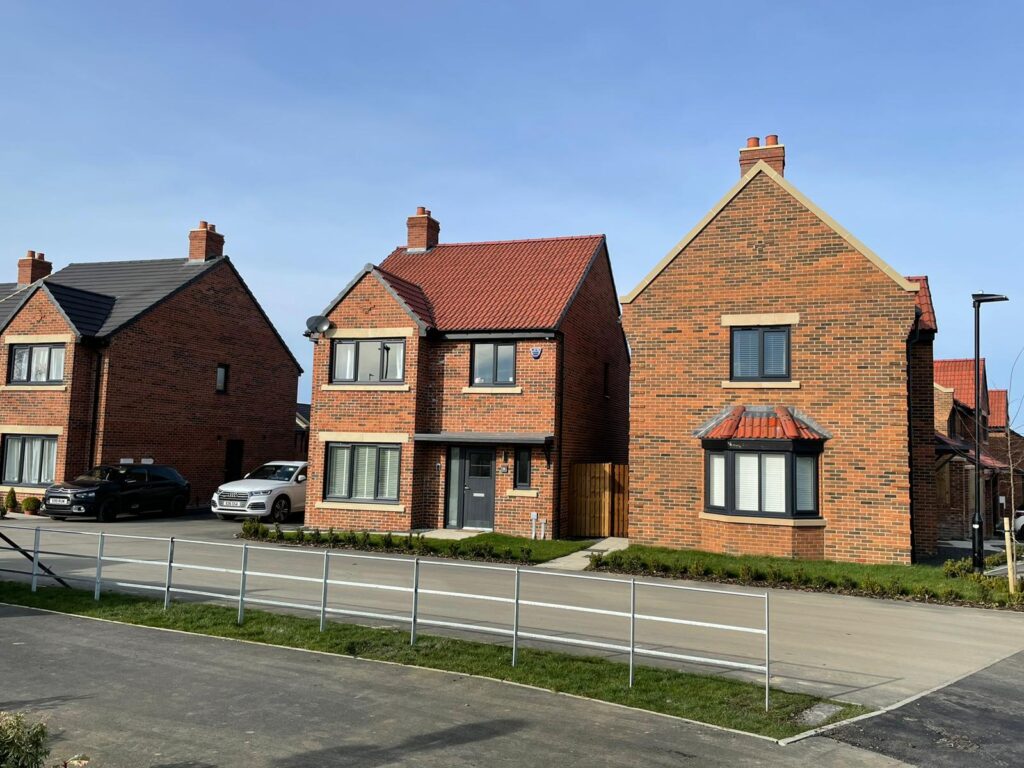 Newly built modern houses with two flue lite-stack GRP chimney stacks