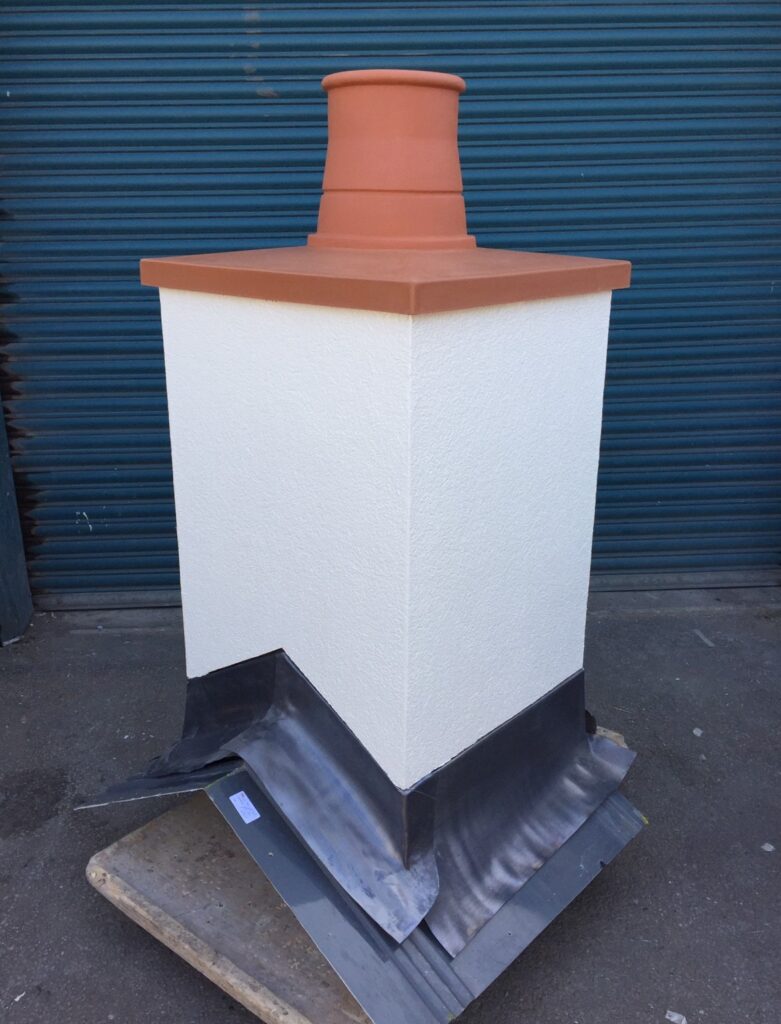 A white render-effect GRP chimney with a red flue and top